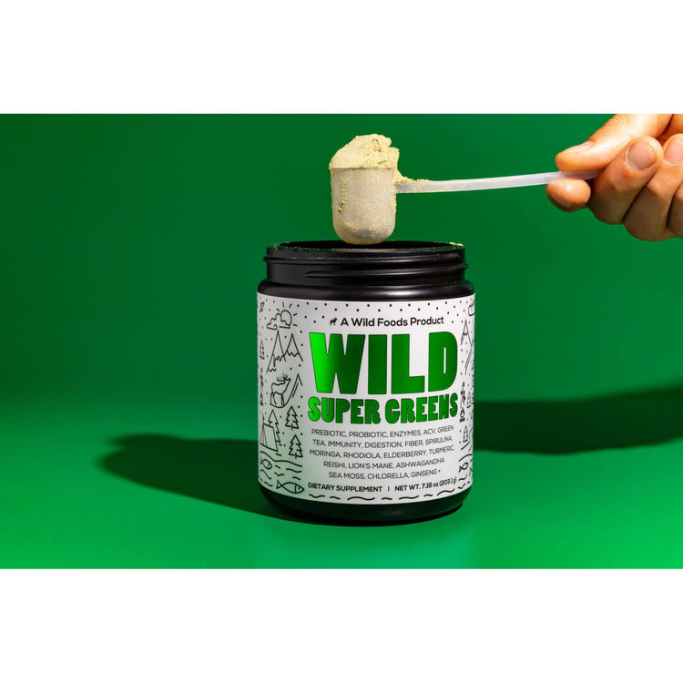 https://www.wildfoods.co/cdn/shop/files/Harsh-Shadow-Green-BG-Hand--Super-Greens_750x750.jpg?v=1685993542